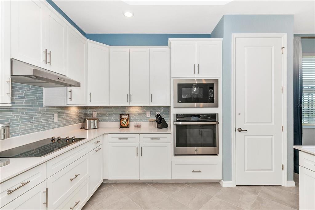17180 Jadestone Court Venice, FL 34293 - Photo 4 of 98 a kitchen with granite countertop white cabinets and stainless steel appliances