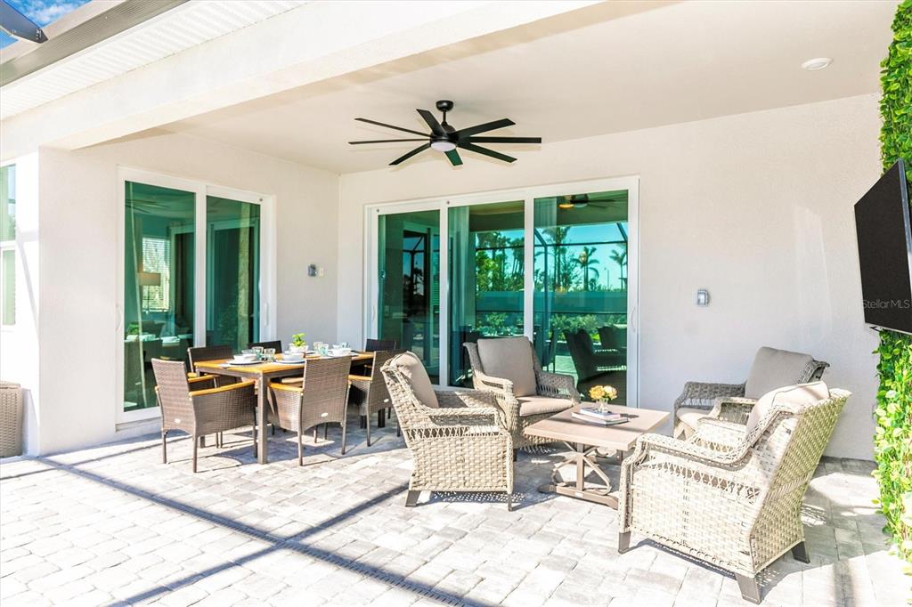 17180 Jadestone Court Venice, FL 34293 - Photo 45 of 98 a living room with patio furniture and a large window