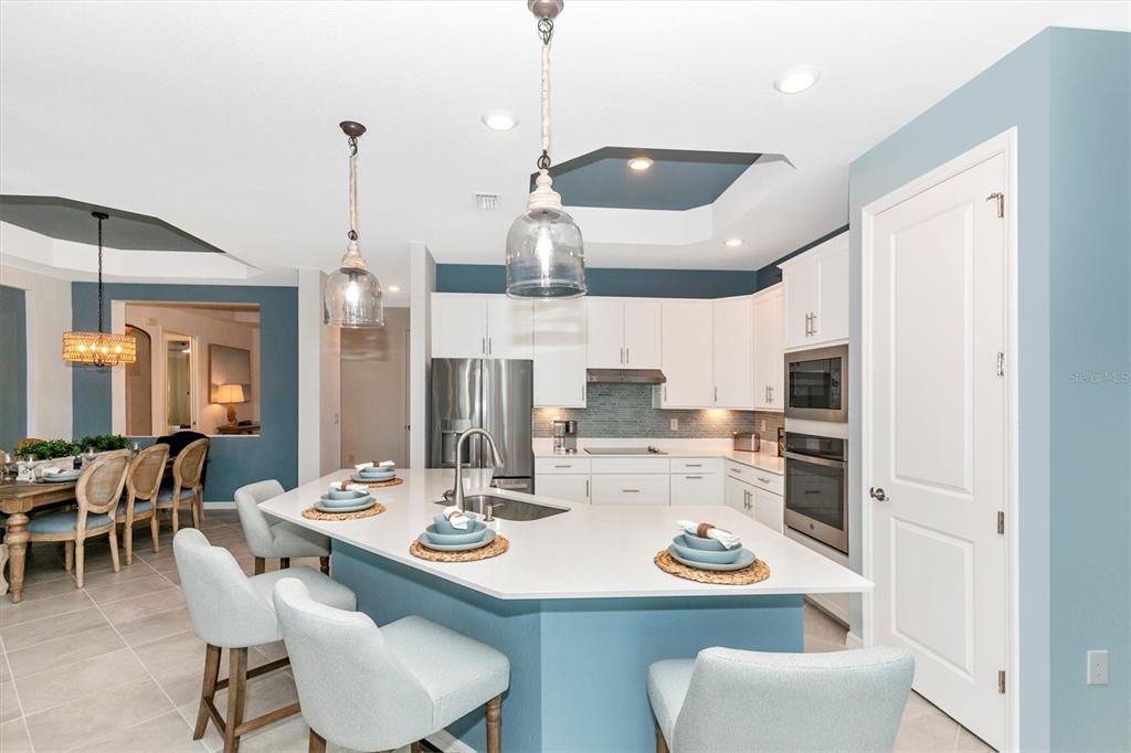 17180 Jadestone Court Venice, FL 34293 - Photo 6 of 98 a kitchen with a dining table and chairs