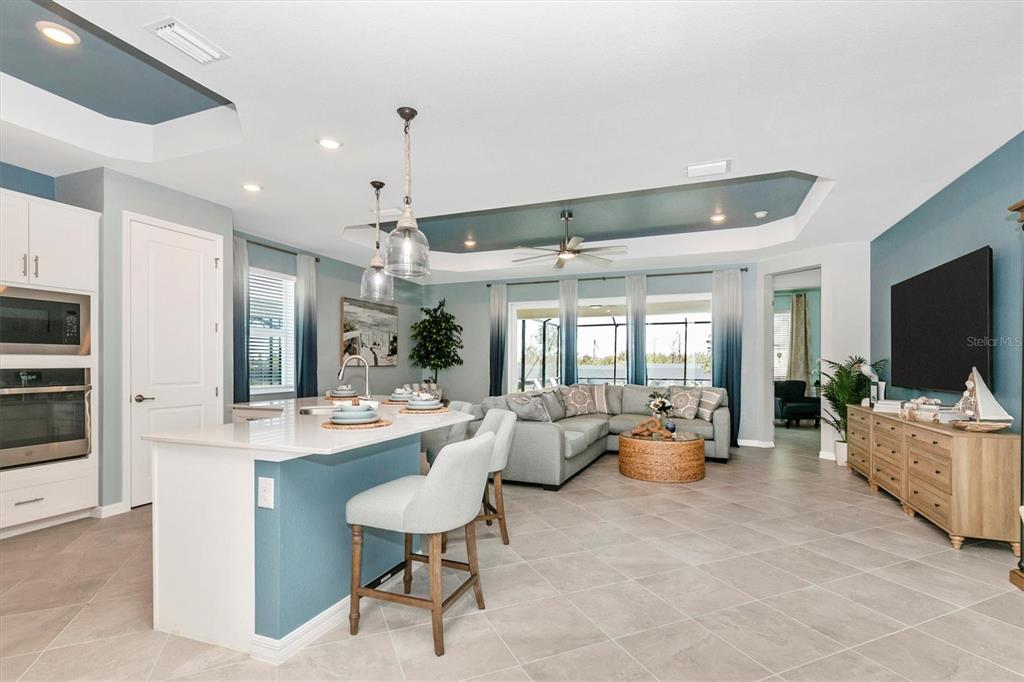 17180 Jadestone Court Venice, FL 34293 - Photo 9 of 98 a living room with furniture and a flat screen tv