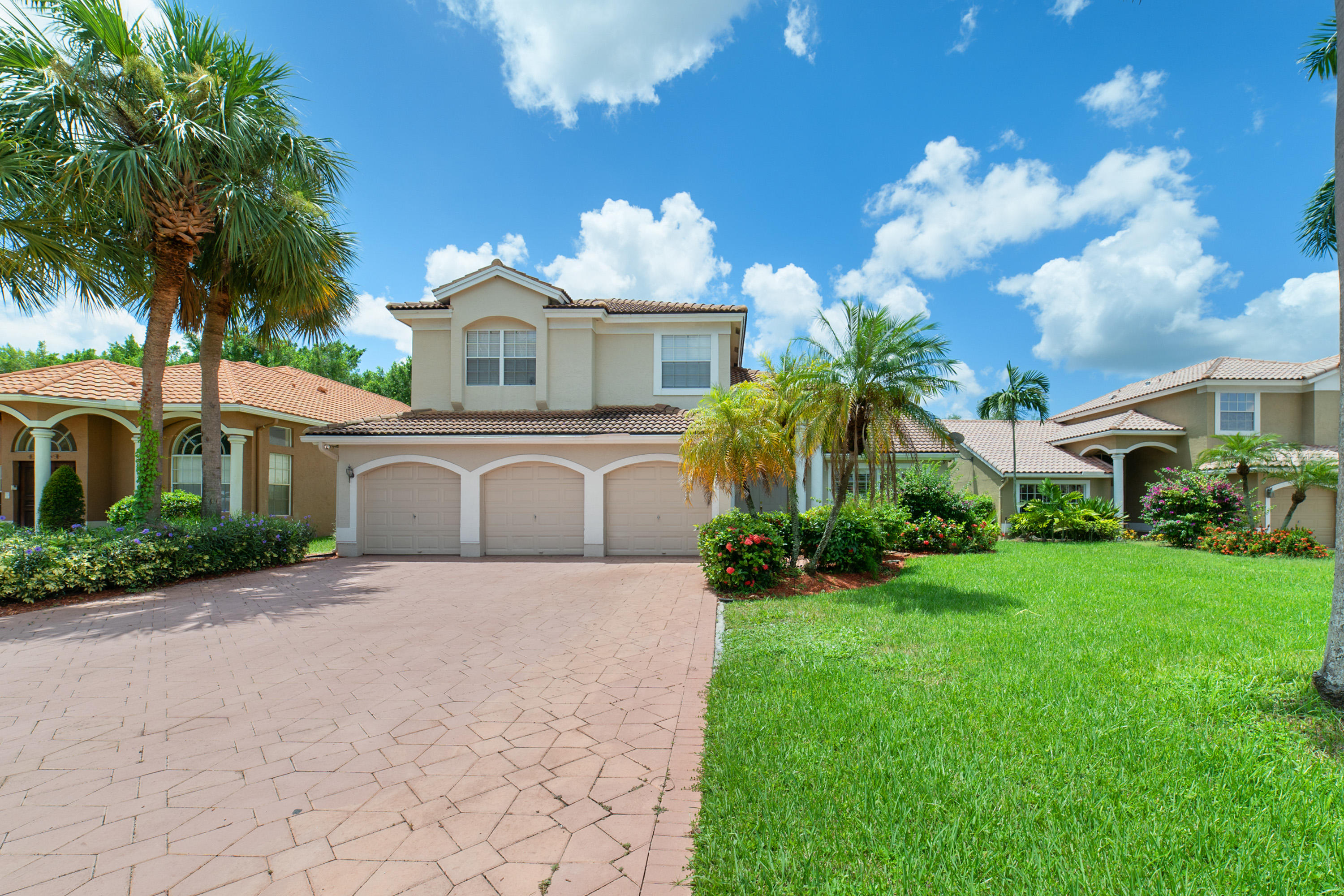 a front view of a house with a yard and a garage