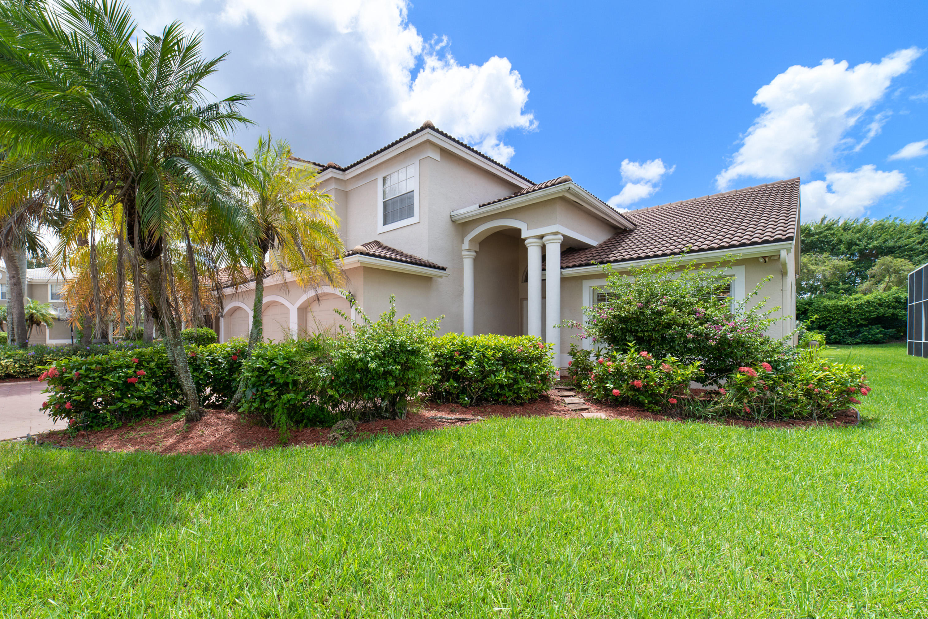19554 Black Olive Lane Boca Raton, FL 33498 - Photo 2 of 40 a front view of a house with a garden