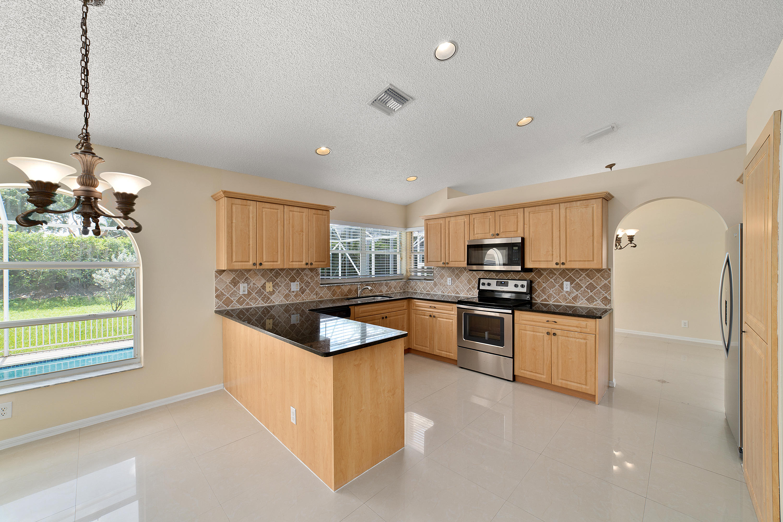 19554 Black Olive Lane Boca Raton, FL 33498 - Photo 15 of 40 a kitchen with stainless steel appliances granite countertop a stove and a refrigerator