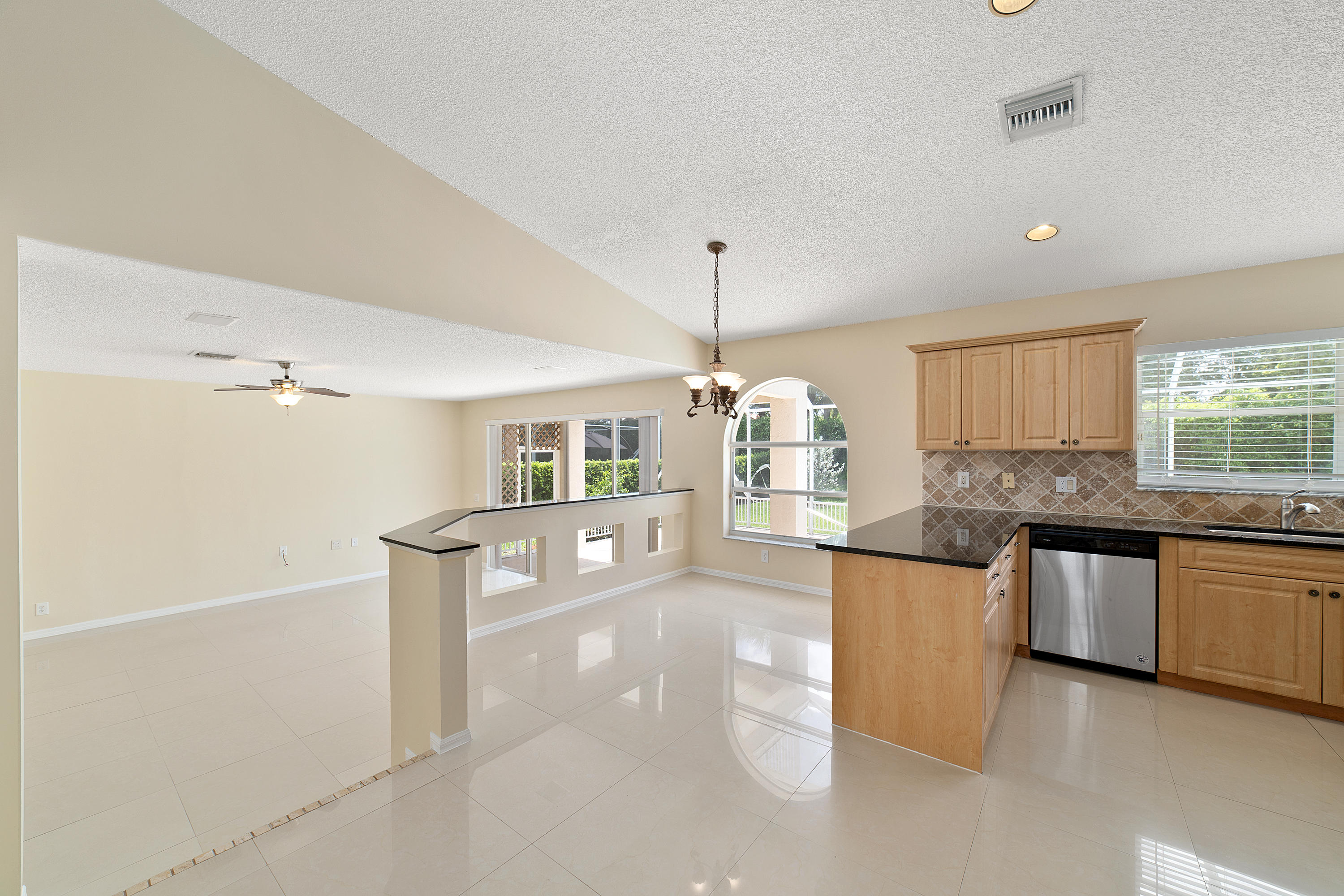 19554 Black Olive Lane Boca Raton, FL 33498 - Photo 16 of 40 a large kitchen with kitchen island a sink stainless steel appliances and cabinets