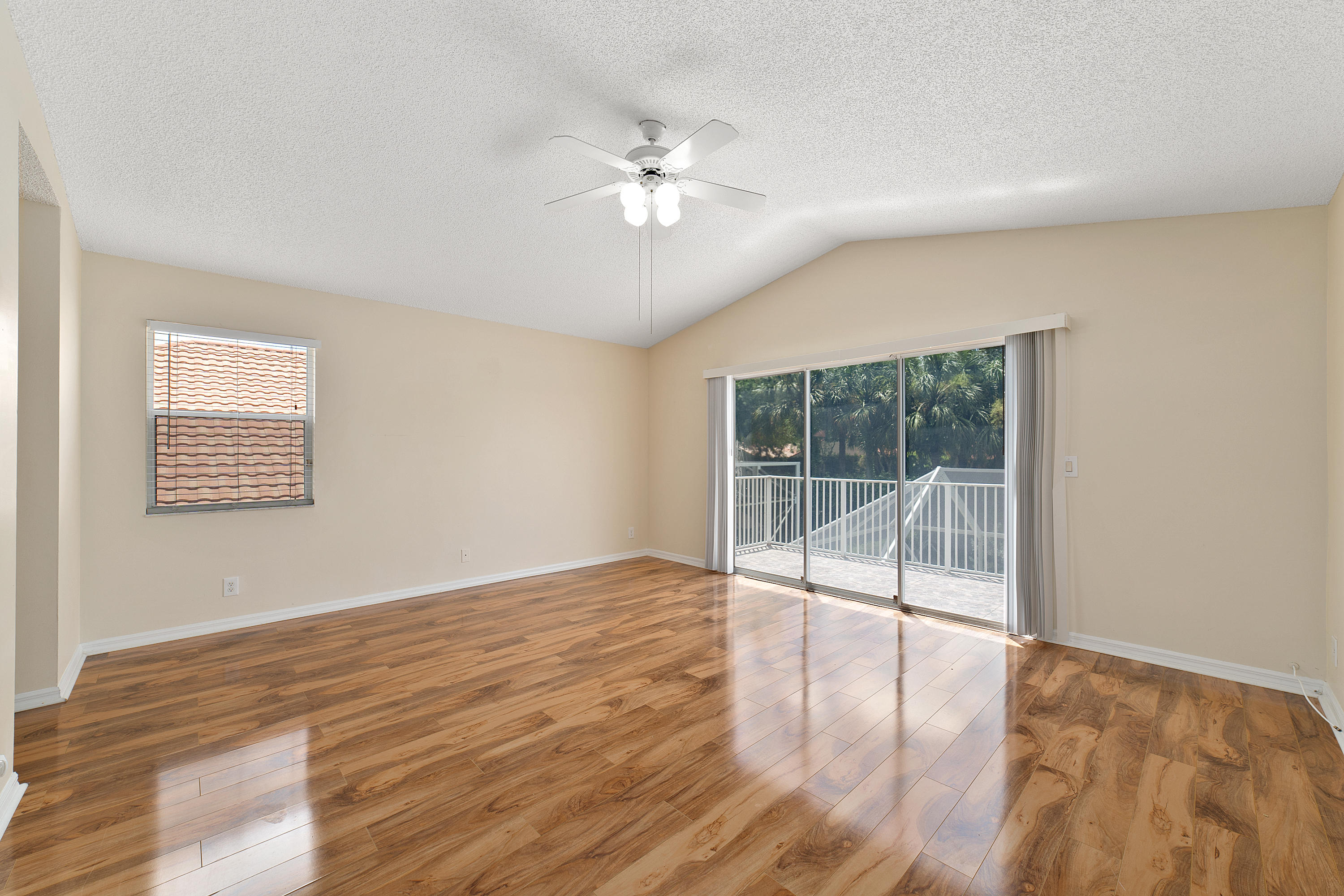 19554 Black Olive Lane Boca Raton, FL 33498 - Photo 19 of 40 a view of an empty room with wooden floor and a window