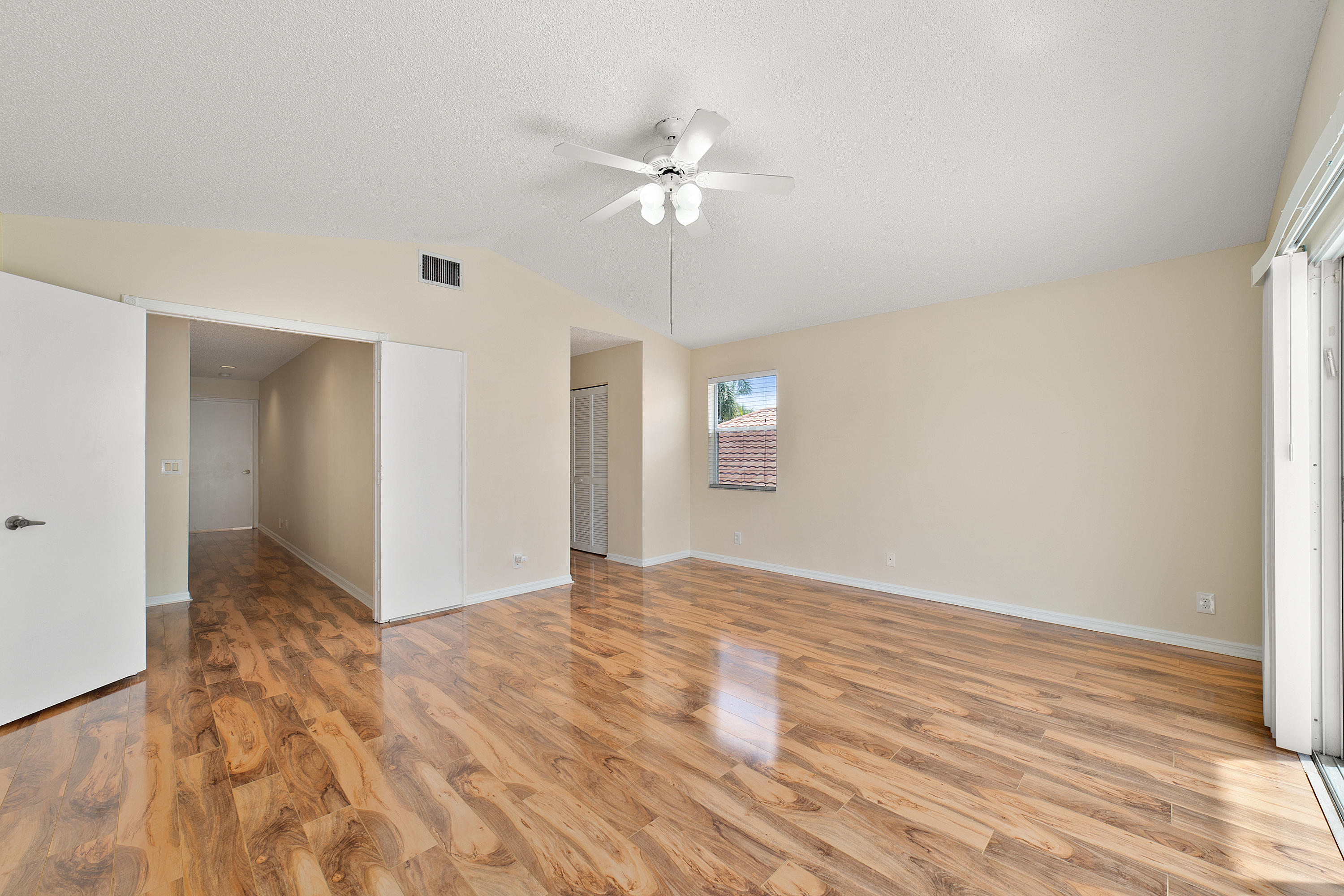 19554 Black Olive Lane Boca Raton, FL 33498 - Photo 20 of 40 a view of an empty room with window and wooden floor