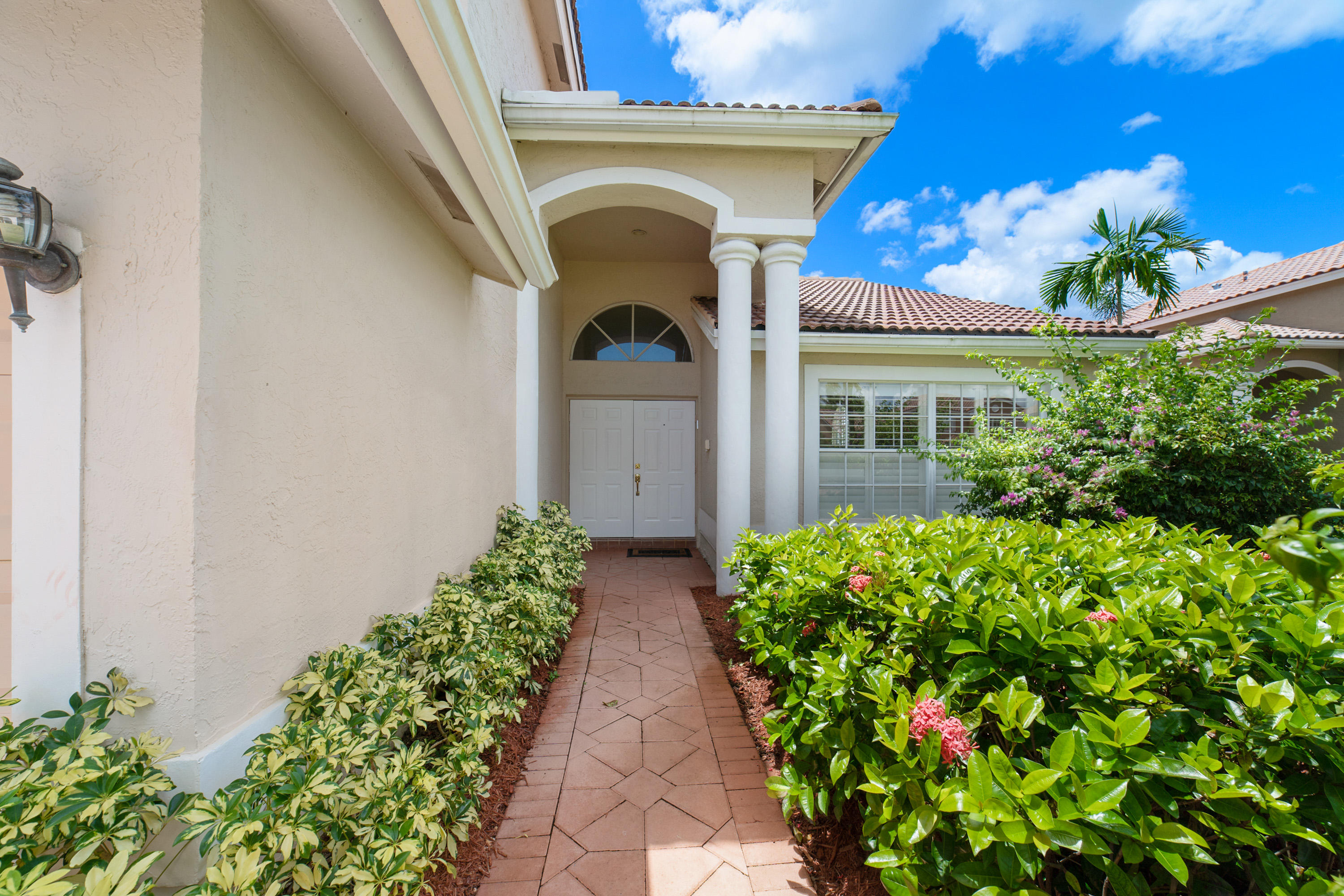 19554 Black Olive Lane Boca Raton, FL 33498 - Photo 3 of 40 a view of the house with flower pots