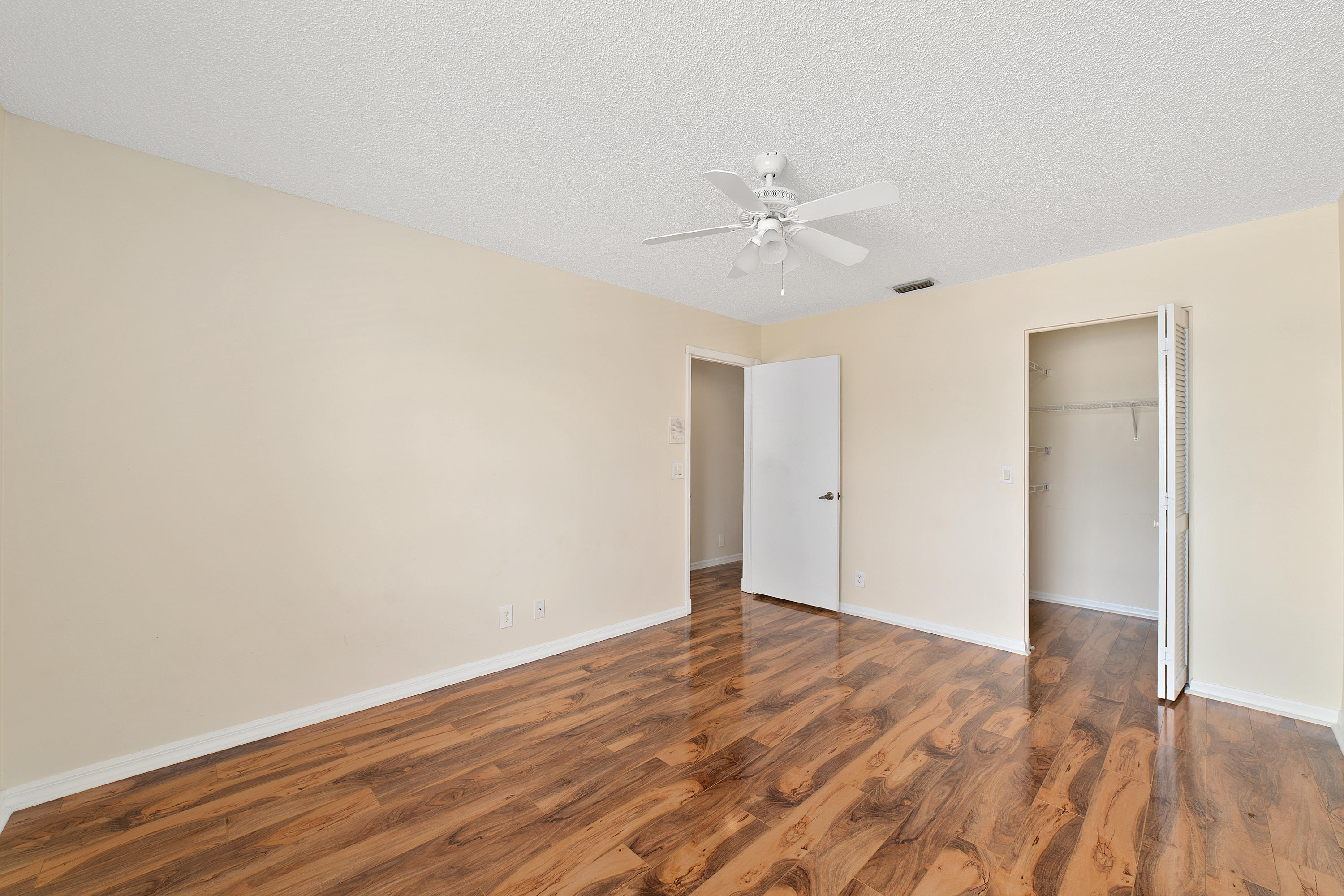 19554 Black Olive Lane Boca Raton, FL 33498 - Photo 25 of 40 a view of an empty room with wooden floor
