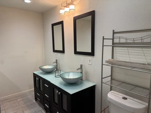 a bathroom with a toilet a sink and mirror