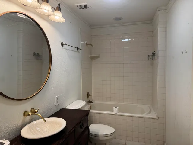a bathroom with a toilet a sink and bathtub