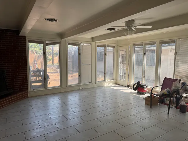 a living room with furniture and large windows