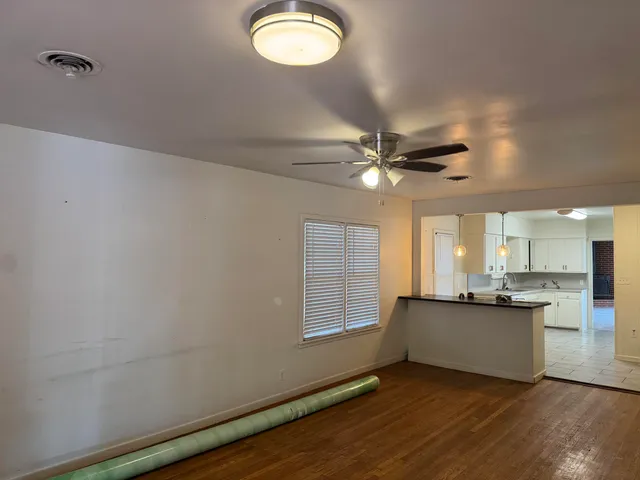 wooden floor in an empty room with a window