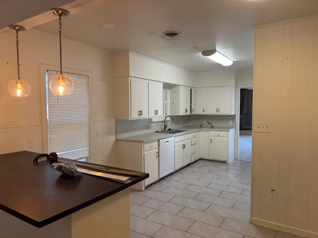 a kitchen with a sink appliances and cabinets