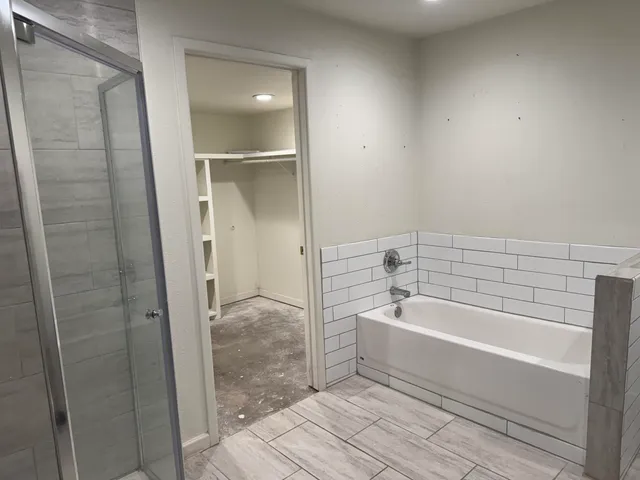 a bathroom with a bathtub and shower