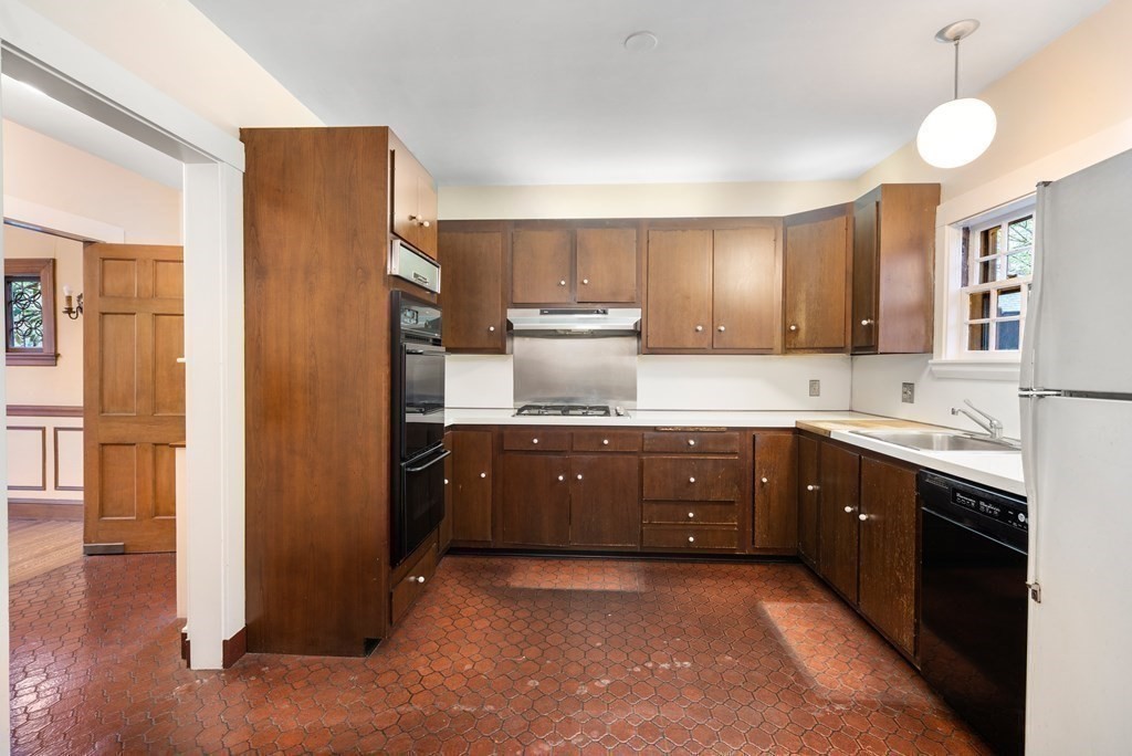110 Cedar Street Newton, MA 02459 - Photo 11 of 28 a kitchen with stainless steel appliances granite countertop a sink refrigerator and cabinets