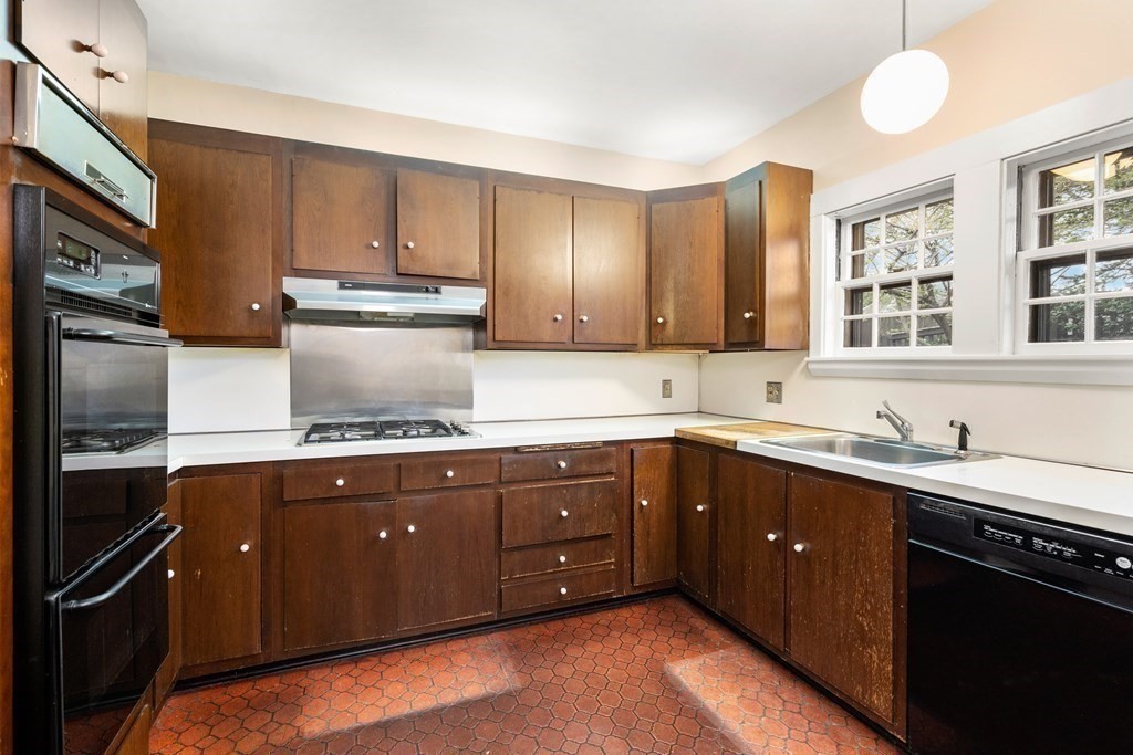 110 Cedar Street Newton, MA 02459 - Photo 12 of 28 a kitchen with a sink stove and refrigerator