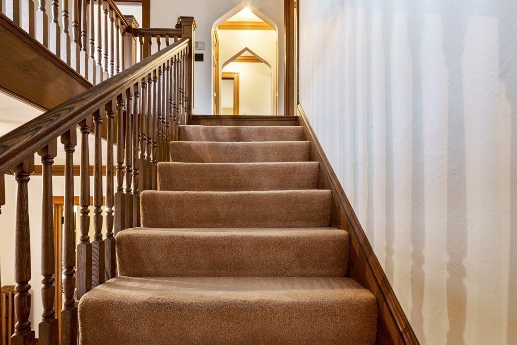 110 Cedar Street Newton, MA 02459 - Photo 13 of 28 a view of staircase with wooden floor and white walls