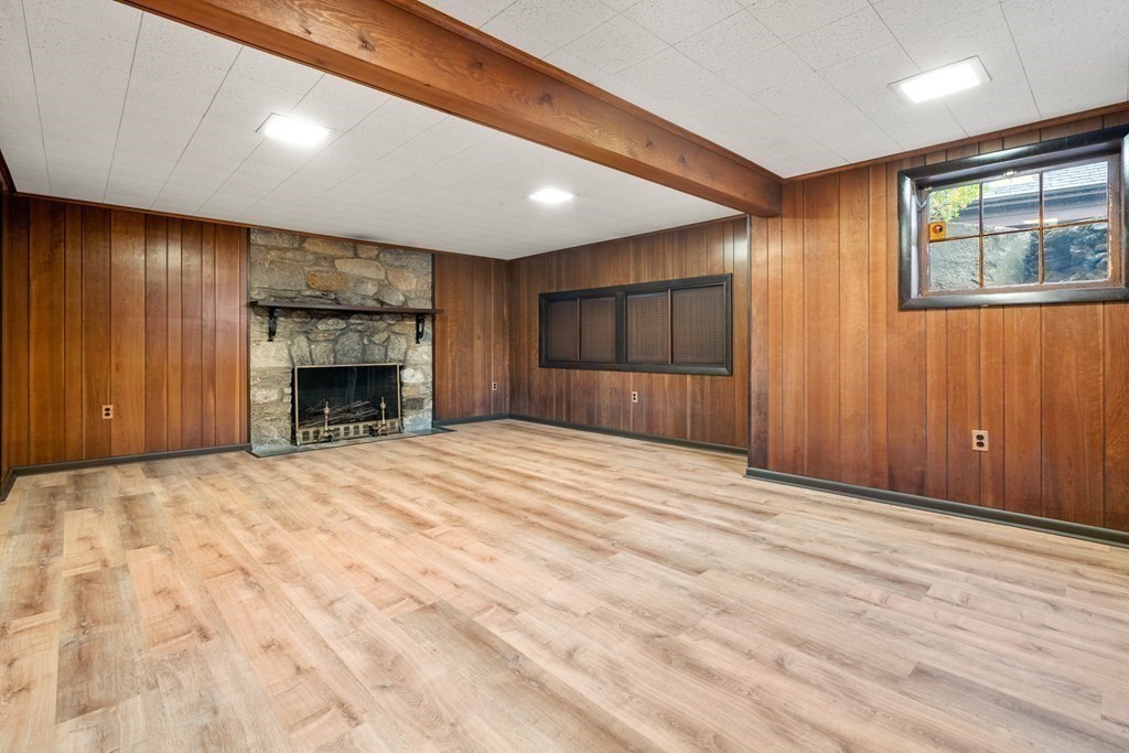 110 Cedar Street Newton, MA 02459 - Photo 24 of 28 a view of empty room with wooden floor and fireplace