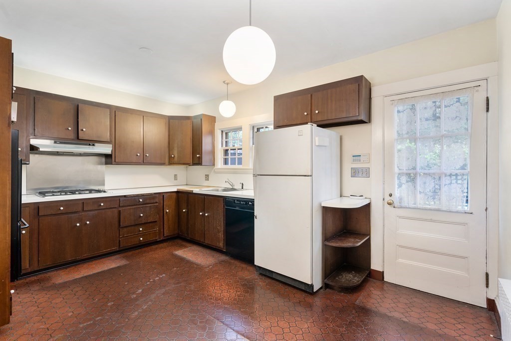 110 Cedar Street Newton, MA 02459 - Photo 10 of 28 a kitchen with sink refrigerator and cabinets