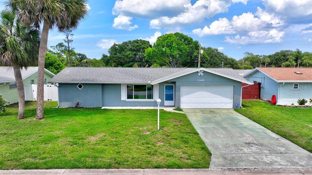 1309 Suwanee Road Daytona Beach, FL 32114 - Photo 27 of 33 a view of a house with a yard and potted plants