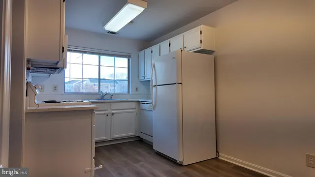 a kitchen with stainless steel appliances a refrigerator and a sink