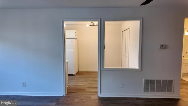 a kitchen with a refrigerator sink and cabinets