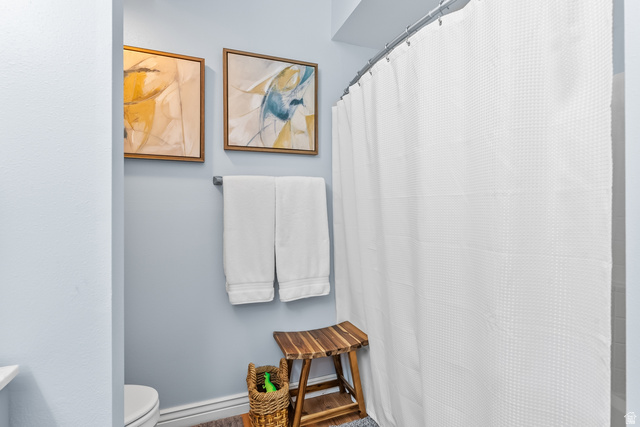 900 Bitner Road, Unit K25 Park City, UT 84098 - Photo 20 of 35 Bathroom featuring light blue walls, wood-finish flooring, and a white shower curtain with a waffle texture