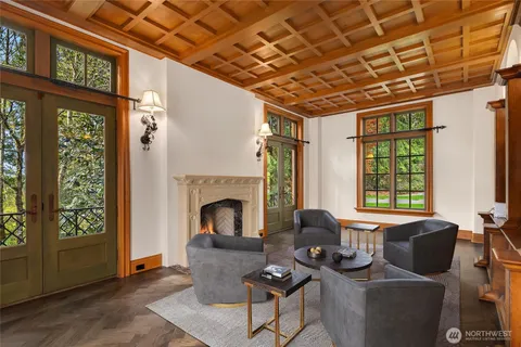 a living room with furniture a wooden floor and a fireplace