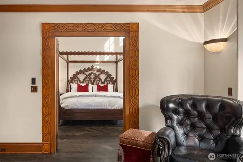 a view of a bedroom with furniture and window