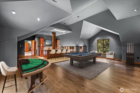 a living room with furniture a rug and a floor to ceiling window