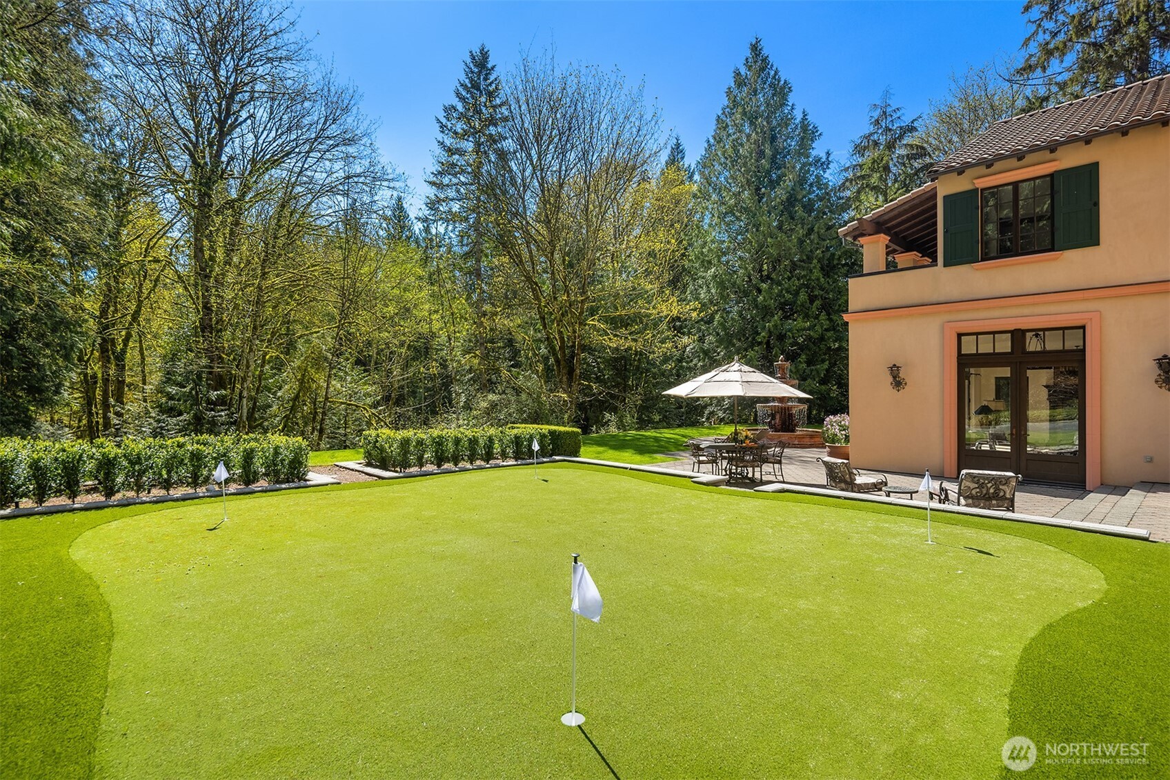 5565 248th Place Southeast Issaquah, WA 98029 - Photo 28 of 33 a view of a swimming pool with lawn chairs and large trees