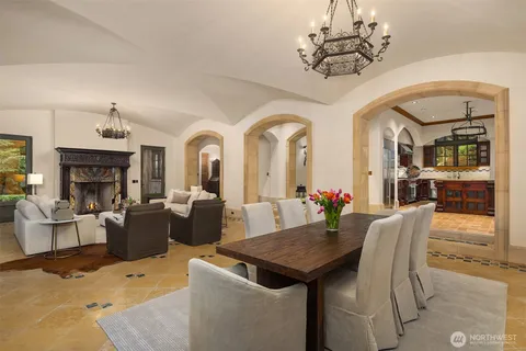 a view of a dining room with furniture a chandelier and wooden floor