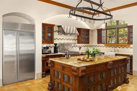 a kitchen with a sink refrigerator and cabinets