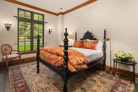 a bed sitting in a bedroom next to a window