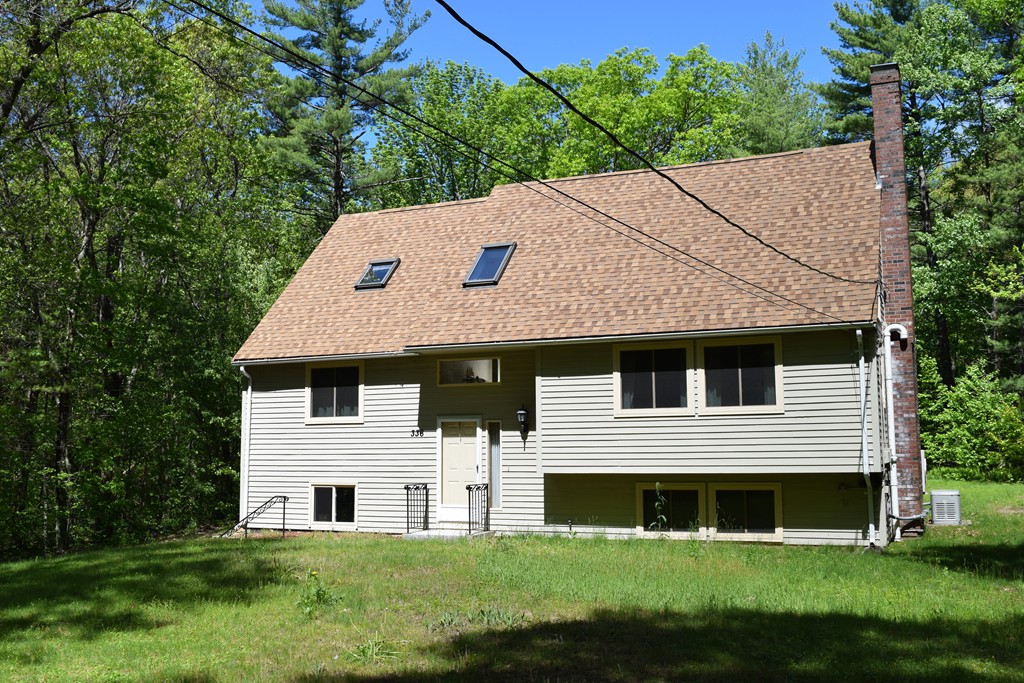 336 Sterling Road Holden, MA 01522 - Photo 3 of 16 a front view of a house with a garden