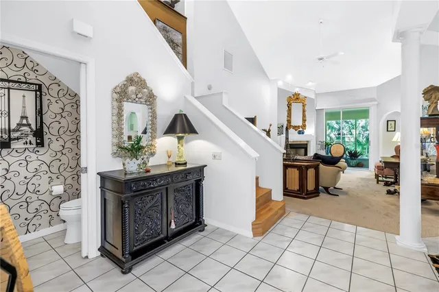 a dining room with furniture a chandelier and window