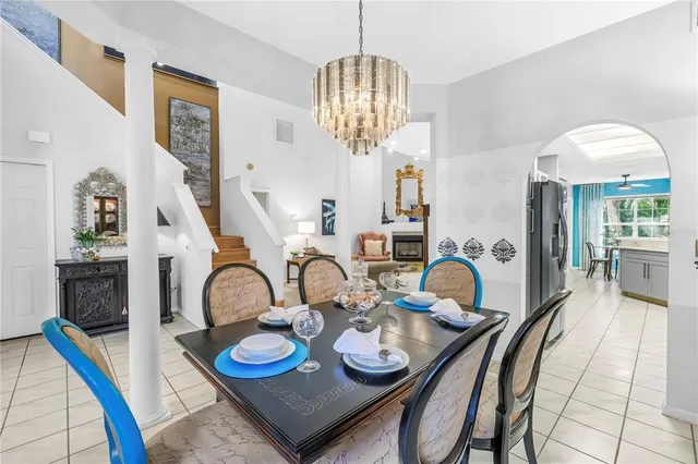 a dining room with furniture and a chandelier