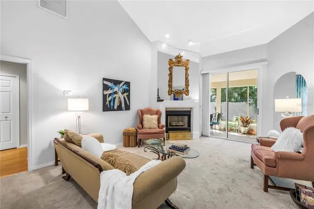 a living room with furniture a fireplace and a window