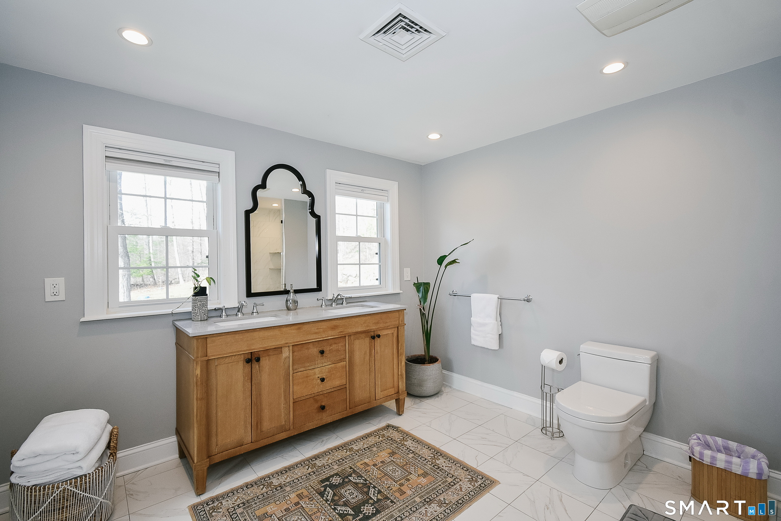 50 1/2 Mountain Spring Road Farmington, CT 06032 - Photo 18 of 28 a spacious bathroom with a granite countertop toilet a sink and a mirror