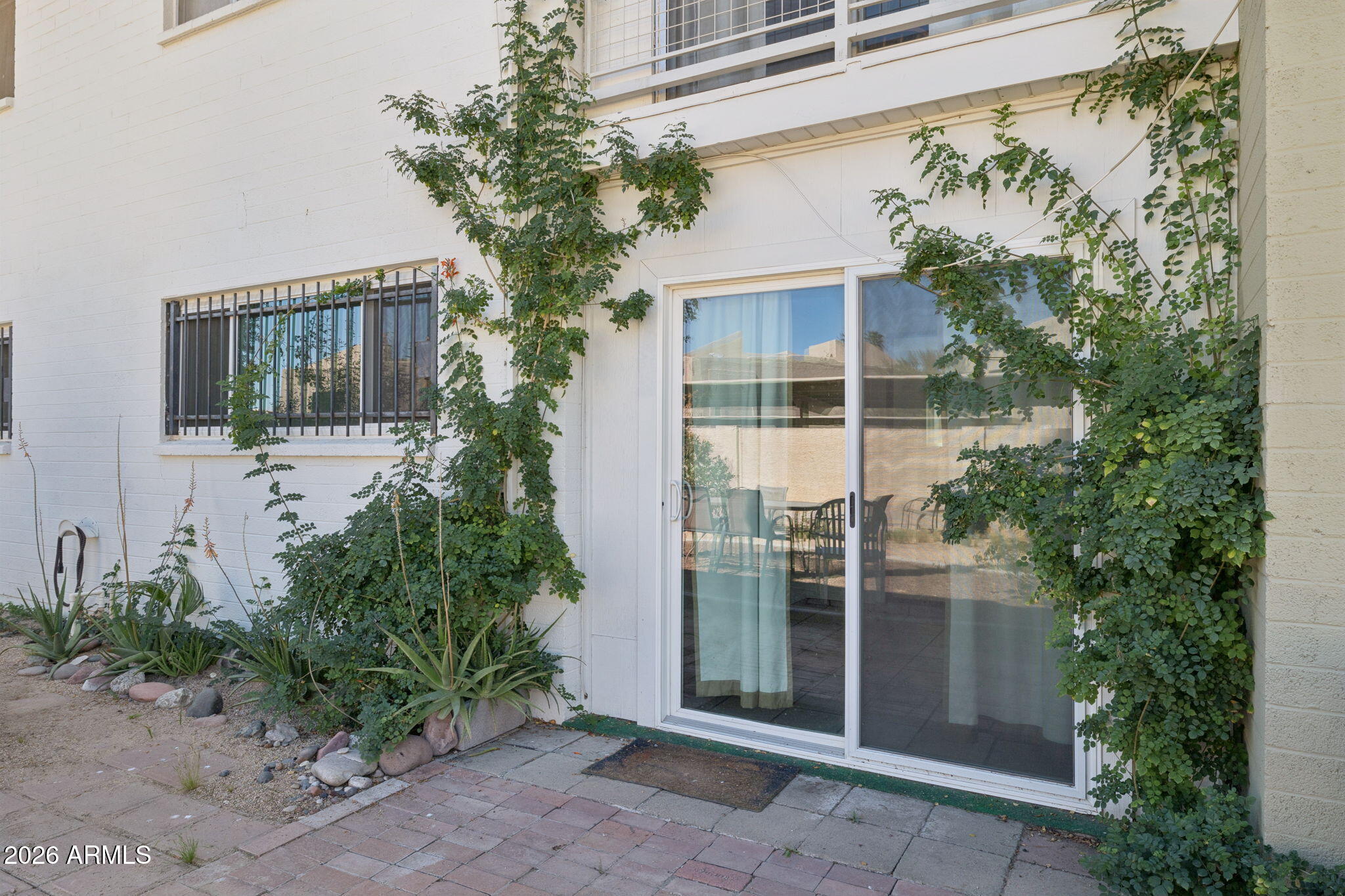 825 North Hayden Road, Unit C104 Scottsdale, AZ 85257 - Photo 19 of 33 a view of a house with a garden