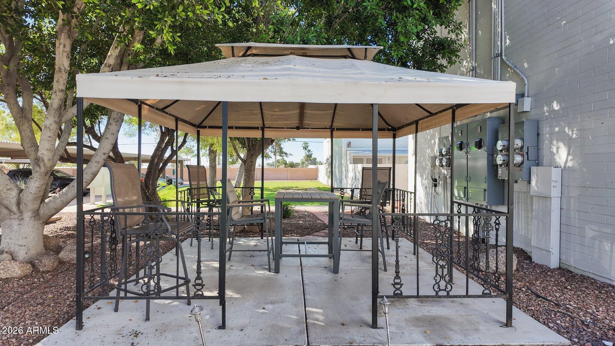 825 North Hayden Road, Unit C104 Scottsdale, AZ 85257 - Photo 27 of 33 a view of patio with chairs and table under an umbrella
