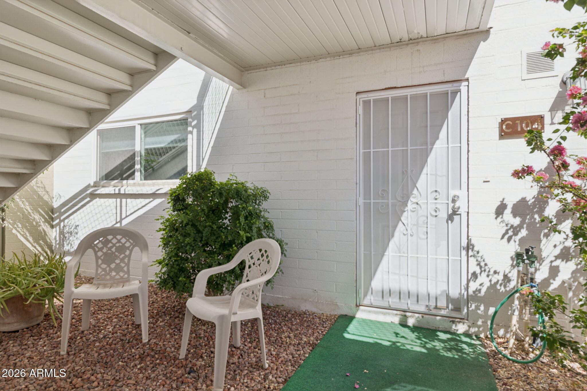 825 North Hayden Road, Unit C104 Scottsdale, AZ 85257 - Photo 2 of 33 a balcony with table and chairs and potted plants