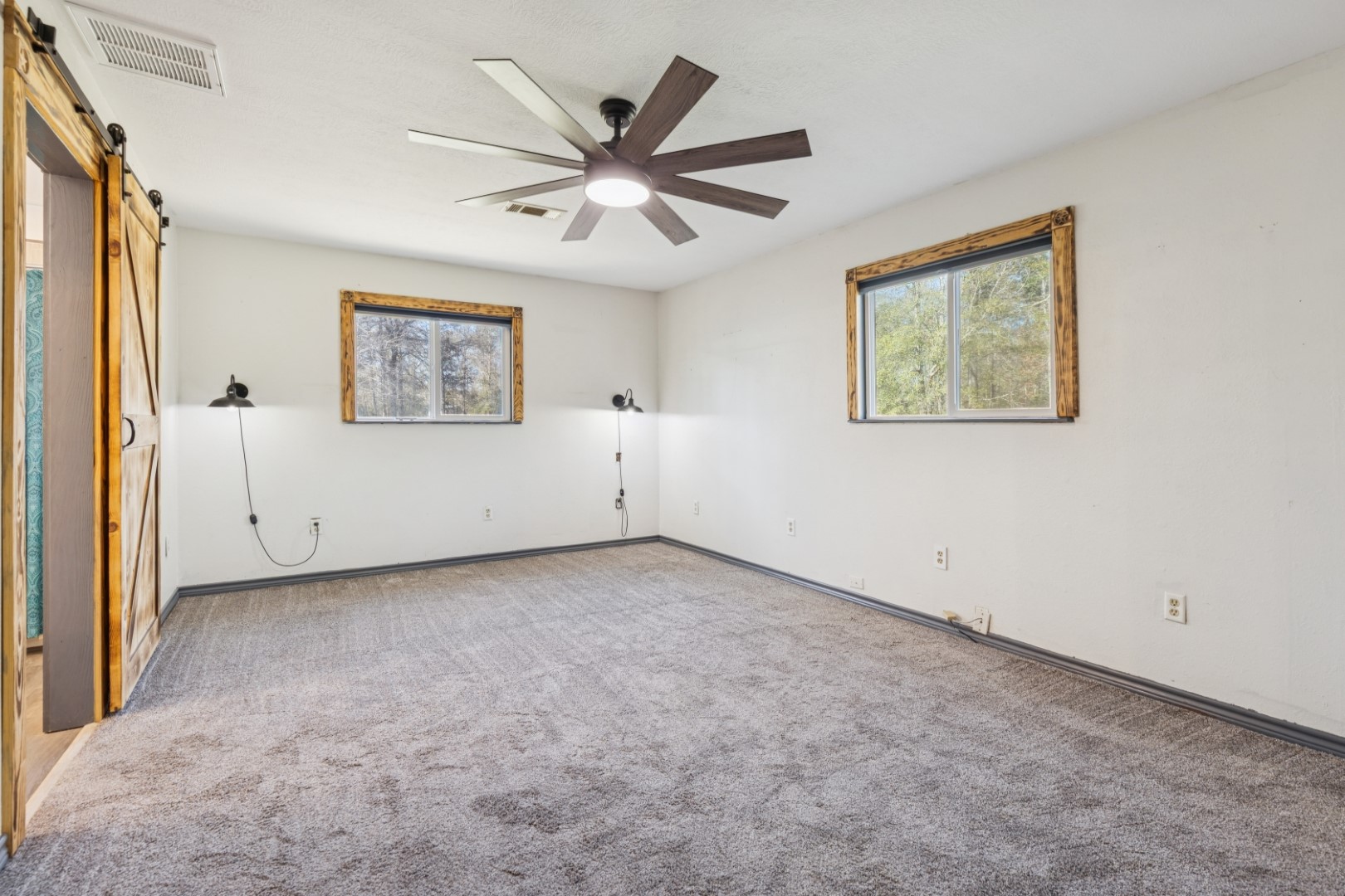 392 Robert E Lee Road Livingston, TX 77351 - Photo 17 of 43 an empty room with windows and fan