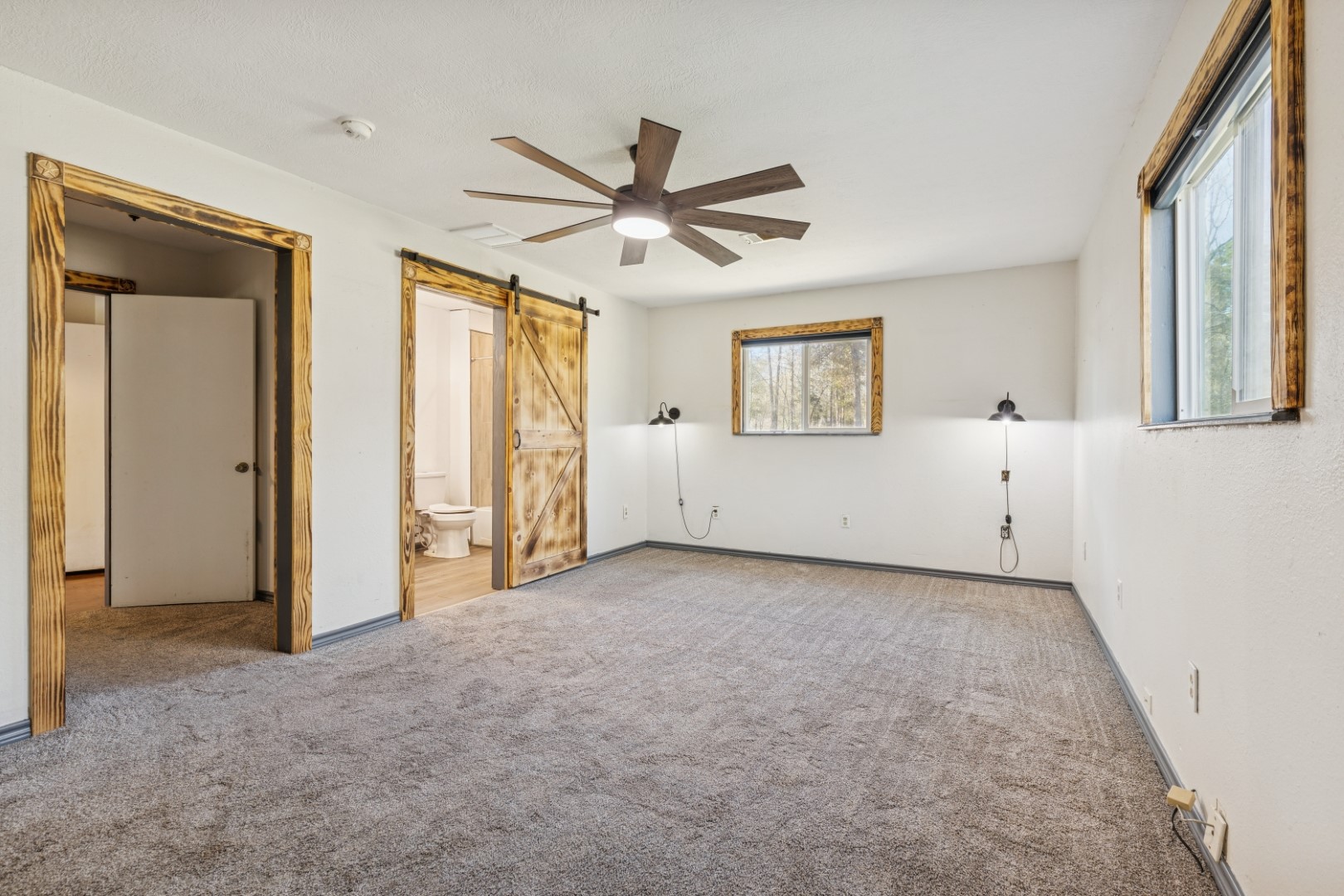392 Robert E Lee Road Livingston, TX 77351 - Photo 18 of 43 an empty room with windows and fan