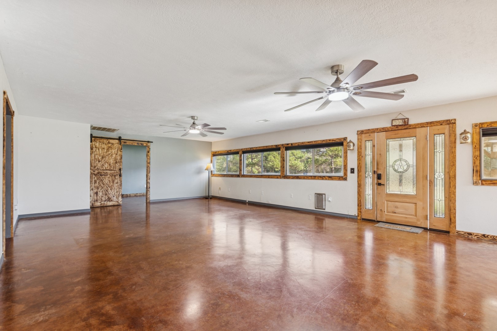 392 Robert E Lee Road Livingston, TX 77351 - Photo 6 of 43 a view of an empty room with a window and wooden floor