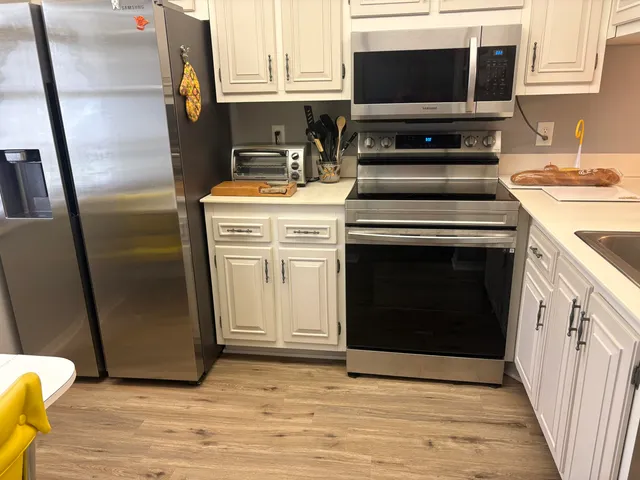 a kitchen with a stove and a microwave