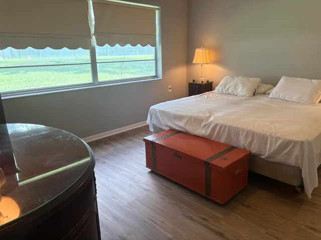 a bedroom with a bed and window