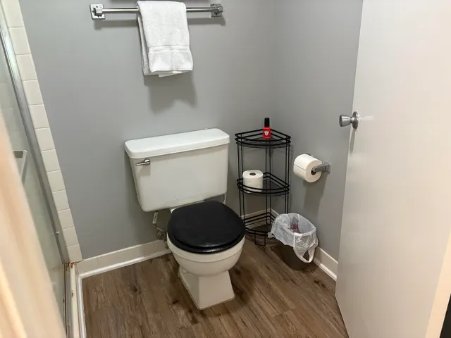 a white toilet sitting next to a small sink