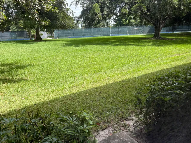 a view of yard with swimming pool and green space