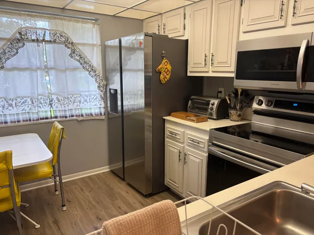 a view of kitchen and wooden floor